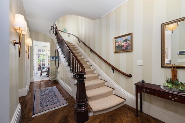 entryway featuring wallpapered walls, baseboards, stairs, and wood finished floors