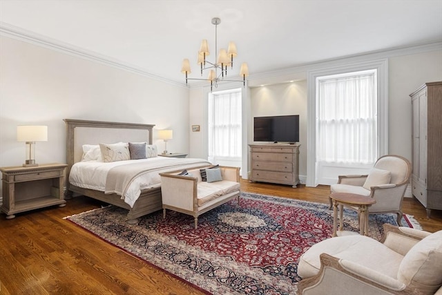 bedroom with wood finished floors, a chandelier, and crown molding