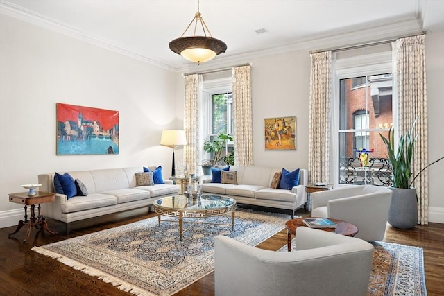 living area featuring visible vents, ornamental molding, baseboards, and wood finished floors