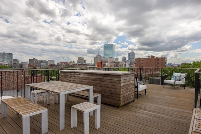 wooden terrace featuring a city view
