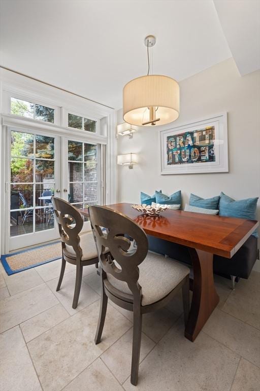 dining space featuring french doors and light tile patterned flooring