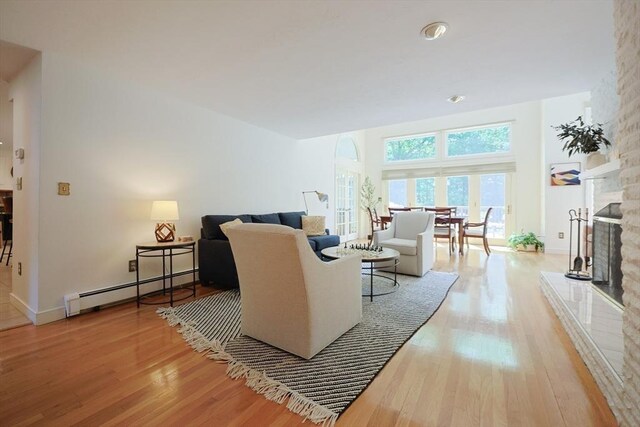 8 Mercer Ln, Franklin, MA 02038 - living room with baseboard heating, wood finished floors, a fireplace, and baseboards