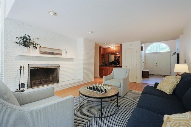 8 Mercer Ln, Franklin, MA 02038 - living area with light wood-style floors and a brick fireplace