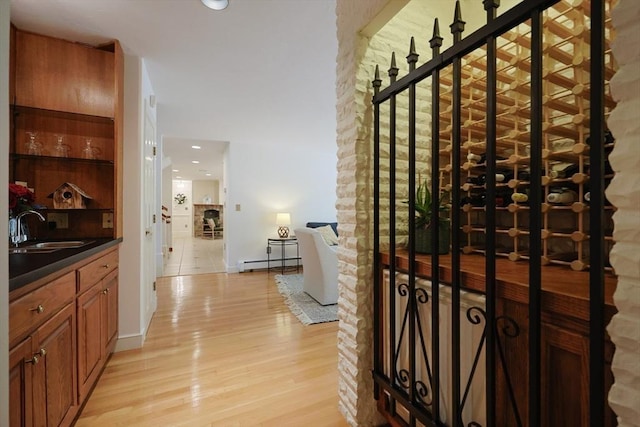 8 Mercer Ln, Franklin, MA 02038 - wine room with a sink, light wood-style flooring, a baseboard radiator, recessed lighting, and baseboards