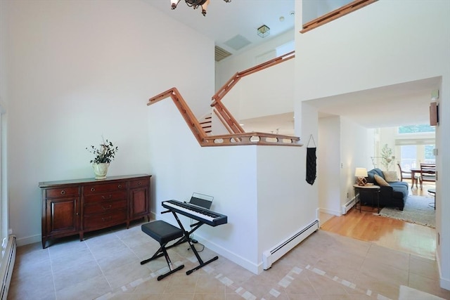 8 Mercer Ln, Franklin, MA 02038 - stairs with a baseboard heating unit, tile patterned flooring, baseboards, and a high ceiling