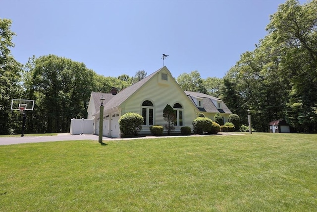 8 Mercer Ln, Franklin, MA 02038 - view of front facade featuring concrete driveway, a front yard, an attached garage, and a chimney
