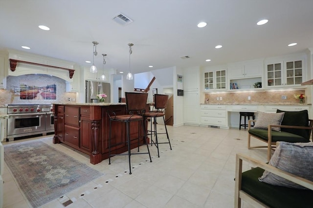 8 Mercer Ln, Franklin, MA 02038 - kitchen featuring stainless steel appliances, decorative backsplash, recessed lighting, a kitchen bar, and custom range hood