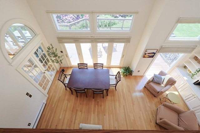 8 Mercer Ln, Franklin, MA 02038 - dining room with a baseboard heating unit, a high ceiling, and wood finished floors