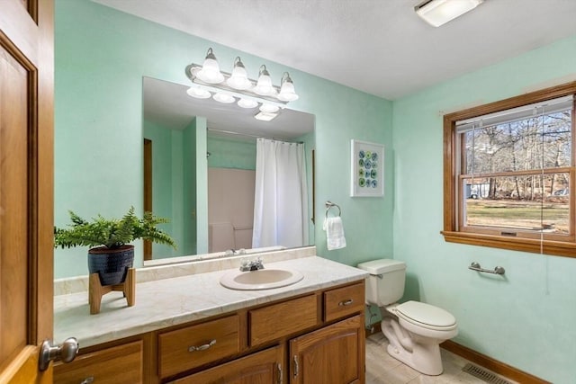 bathroom with tile patterned flooring, vanity, toilet, and a shower with shower curtain