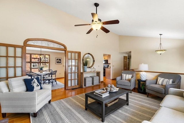 living room featuring ceiling fan, french doors, high vaulted ceiling, and hardwood / wood-style flooring