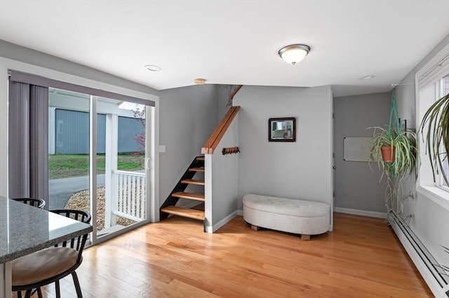 interior space featuring recessed lighting, baseboards, a baseboard radiator, and light wood-type flooring