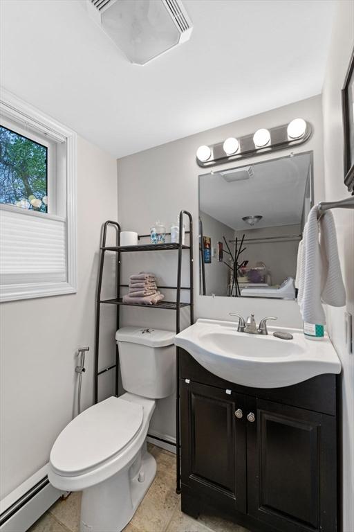 bathroom with vanity, toilet, and a baseboard radiator