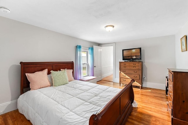 bedroom featuring light wood-type flooring and baseboards