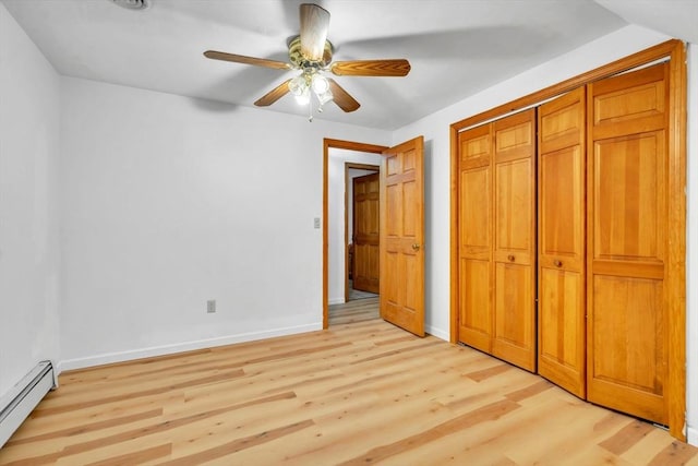 unfurnished bedroom featuring a closet, ceiling fan, light hardwood / wood-style flooring, and baseboard heating