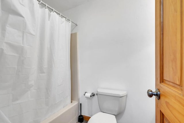 bathroom with toilet and shower / bath combination with curtain