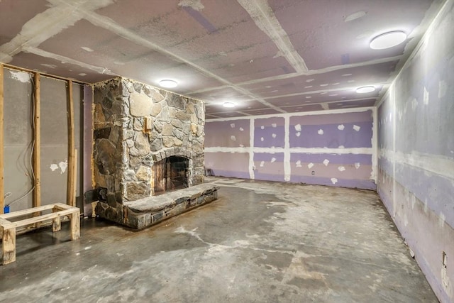 basement featuring a stone fireplace