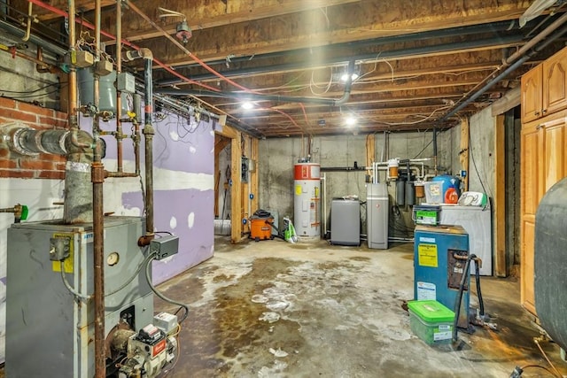 basement featuring water heater and washer / clothes dryer