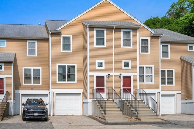 77 Camelot Unit 77, Worcester, MA 01602 - view of property featuring a garage and driveway