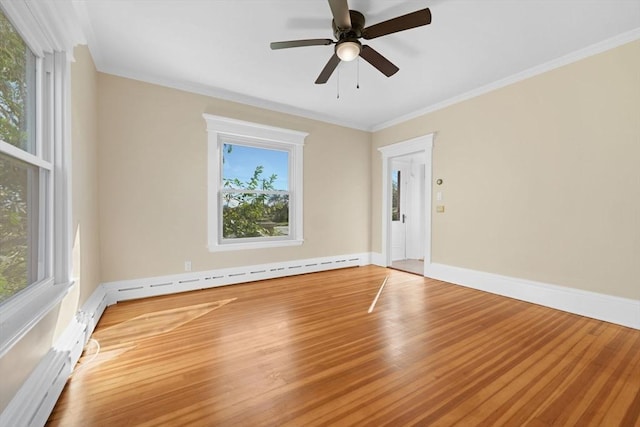 empty room with crown molding, baseboard heating, light wood-style floors, ceiling fan, and baseboards