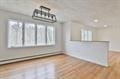 unfurnished dining area with wood finished floors and a healthy amount of sunlight