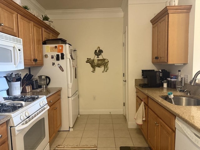 kitchen featuring brown cabinetry, white appliances, crown molding, and a sink