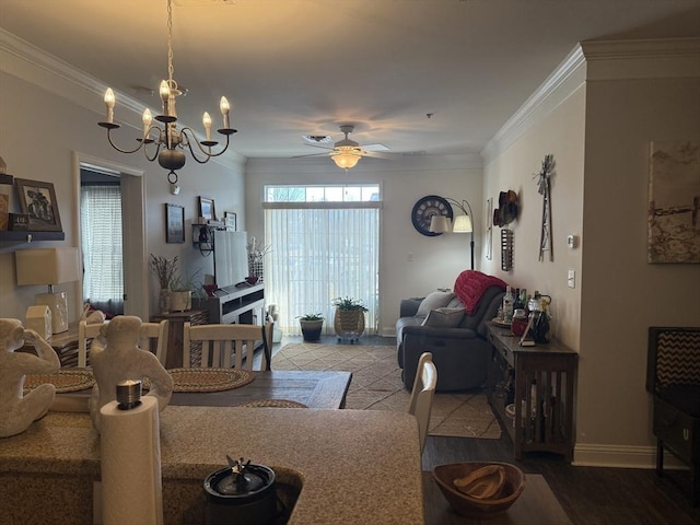 dining room featuring ceiling fan with notable chandelier, baseboards, and crown molding