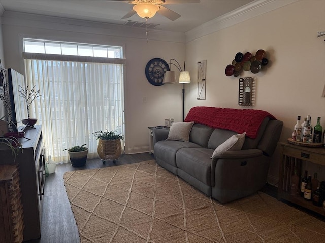 living area with a ceiling fan, crown molding, and wood finished floors