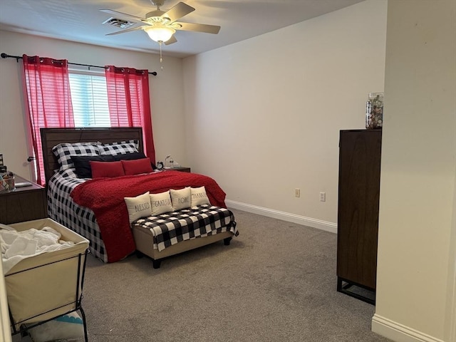 carpeted bedroom featuring ceiling fan, visible vents, and baseboards