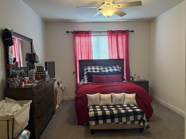 carpeted bedroom with multiple windows, baseboards, and a ceiling fan