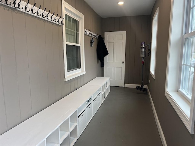 mudroom featuring baseboards and finished concrete floors