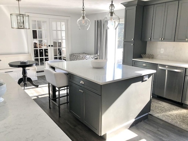 kitchen with french doors, gray cabinets, stainless steel dishwasher, and dark wood finished floors