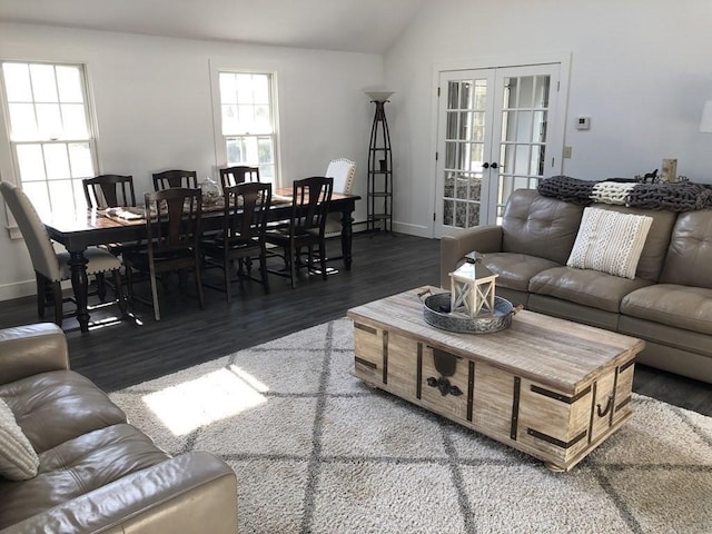 living area with lofted ceiling, french doors, baseboards, and wood finished floors