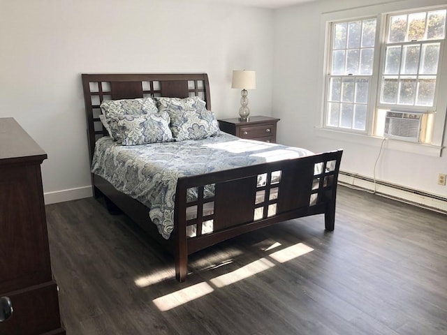 bedroom featuring a baseboard radiator, cooling unit, wood finished floors, and baseboards