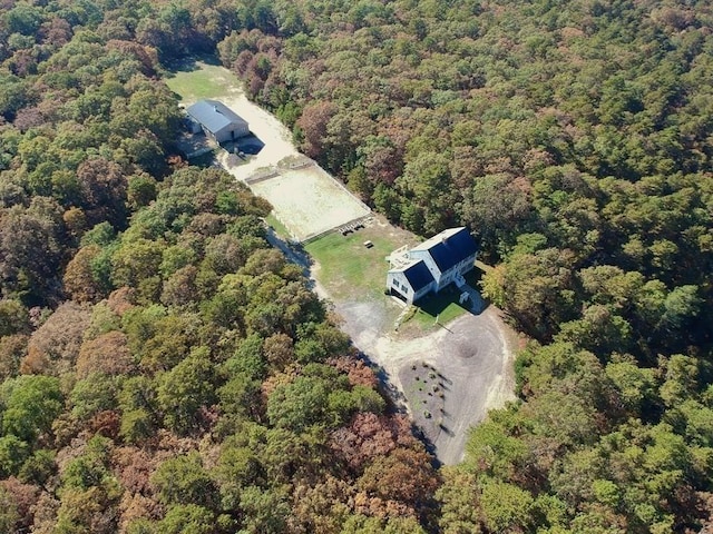 bird's eye view with a wooded view