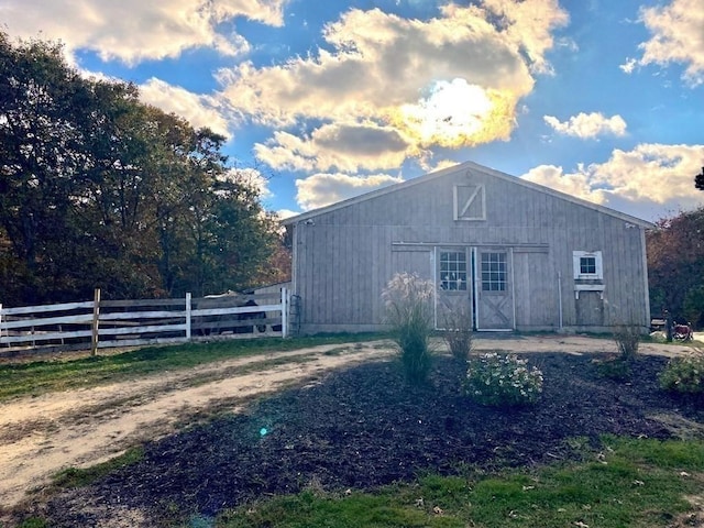 view of barn with fence