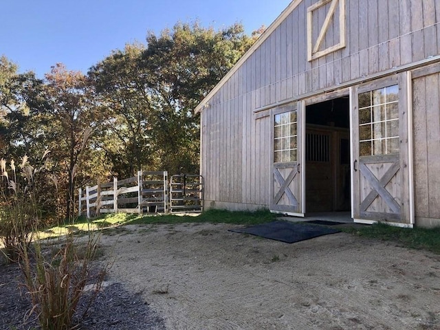 view of barn with fence