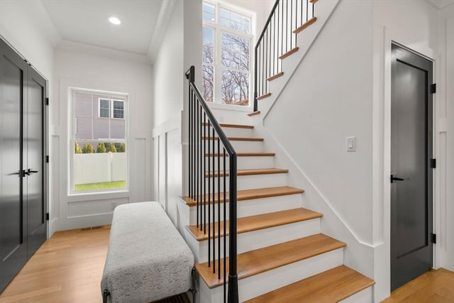 stairs featuring visible vents, recessed lighting, and wood finished floors