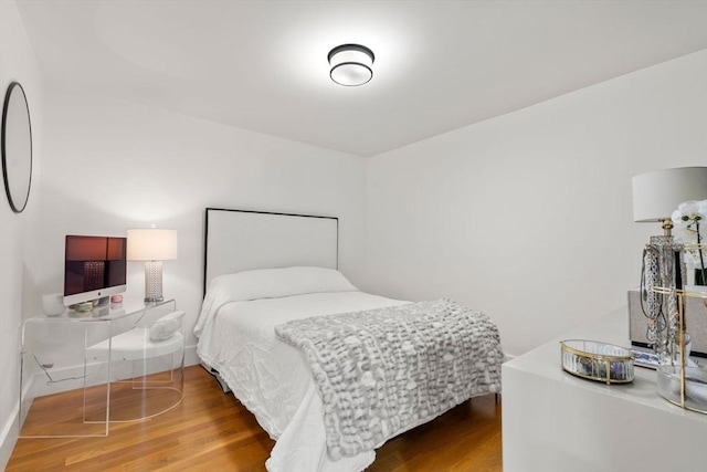 bedroom with wood finished floors