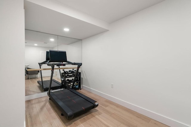 exercise area featuring recessed lighting, baseboards, and wood finished floors