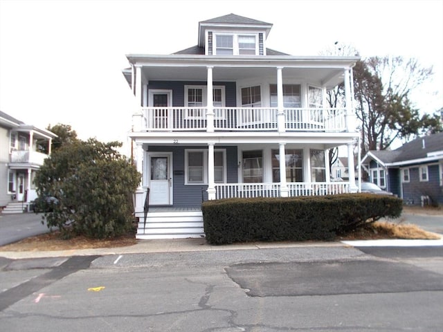 view of front of home featuring covered porch and a balcony