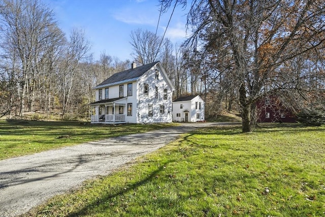 view of home's exterior featuring a lawn and a porch