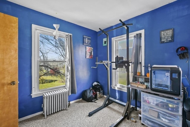 exercise area with carpet floors and radiator heating unit