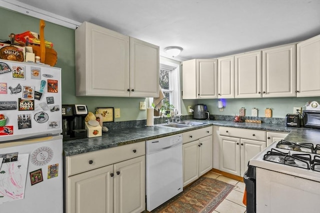 kitchen featuring light tile patterned flooring, sink, white cabinets, and white appliances