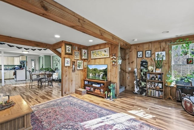 living room with wood walls and light wood-type flooring