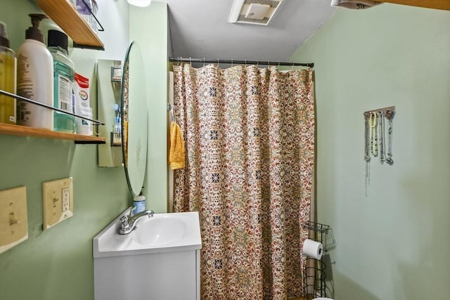 bathroom with vanity and curtained shower