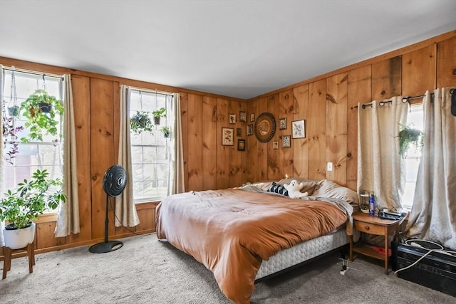 carpeted bedroom with wood walls