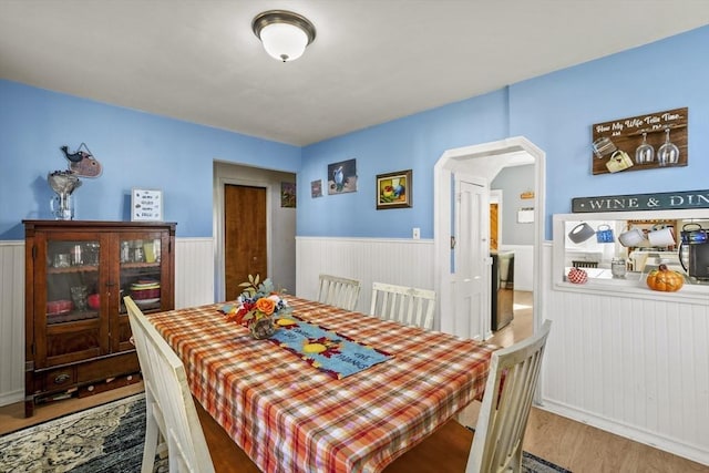 dining space with wood-type flooring