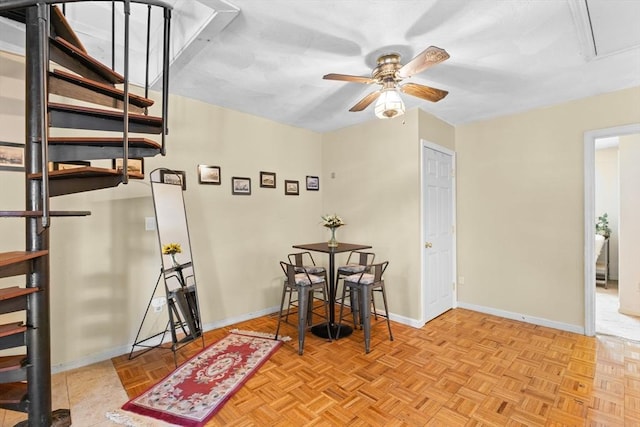 dining room with ceiling fan and light parquet floors