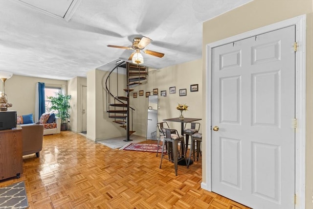 entrance foyer featuring ceiling fan and light parquet floors