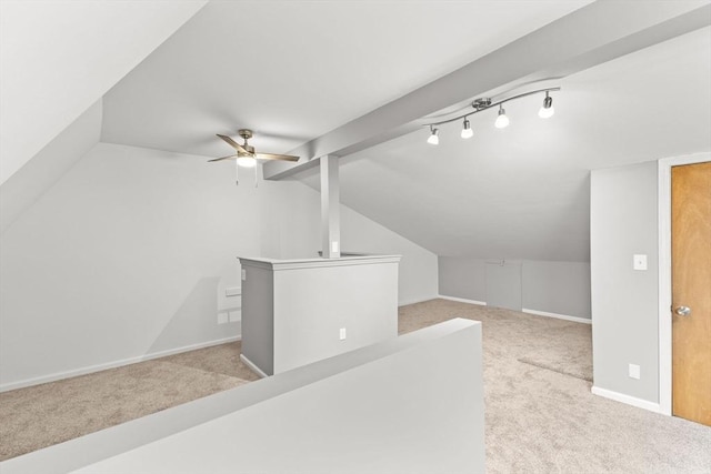 additional living space featuring vaulted ceiling, light colored carpet, and ceiling fan